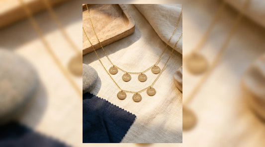A layered grandma necklace with multiple small discs each engraved with a grandchild's name