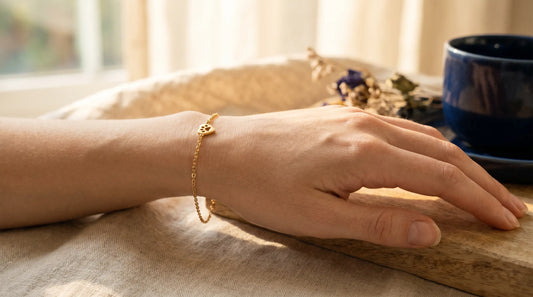 A small 18K gold-plated pendant resting on sensitive skin showing no reaction
