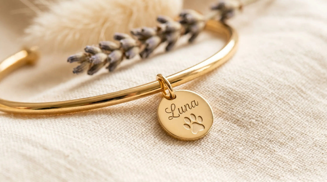 Personalized paw print bracelet with engraved name Luna on cream linen with dried lavender