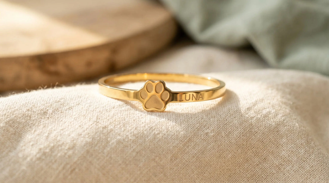 Custom paw print bracelet with engraved pet name in gold-plated stainless steel — pet memorial keepsake