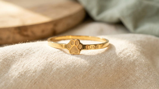 Custom paw print bracelet with engraved pet name in gold-plated stainless steel — pet memorial keepsake