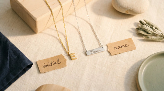 Initial necklace vs name necklace side-by-side comparison flat lay on cream linen