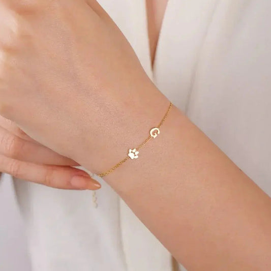 Sideways initial bracelet in gold on lifestyle shot — handmade personalized gift jewelry