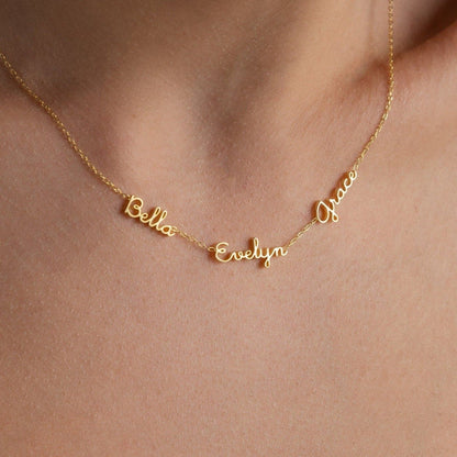 The Dainty Tiny Multiple Name Necklace features three names—Bella, Evelyn, and Grace—in delicate cursive, offering a personalized and elegant accessory for a unique, meaningful touch.